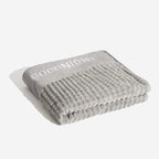 Plush indoor dog bed with bolstered, cushioned sides
