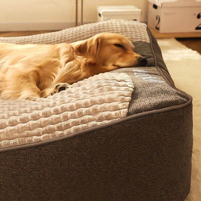 Plush indoor dog bed with bolstered, cushioned sides