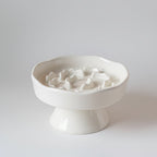 White ceramic elevated slow feeder bowl on a raised foot, sized for cats and small dogs