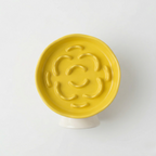 Ceramic slow feeder bowl on a raised stand that helps slow down fast-eating pets