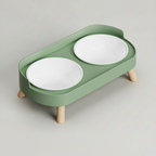 Avocado green elevated double bowl feeder with two plastic bowls on a raised ABS base for food and water