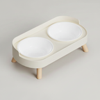 Ivory white elevated double bowl feeder with two plastic bowls side by side on one stable raised stand