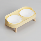 Lemon yellow elevated double bowl feeder with two plastic bowls that lift out of the stand for washing