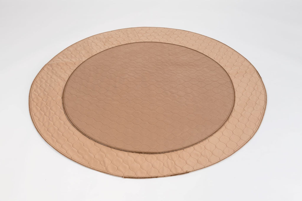 Stack of round EZwhelp brown laminated pads, made in 36, 48 and 60 inch diameters