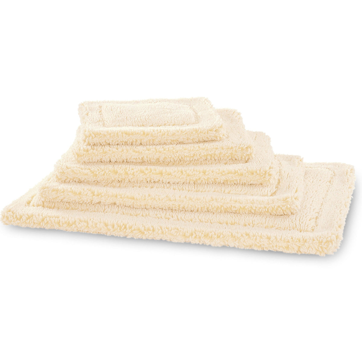 Stack of natural HuggleFleece mats from HuggleHounds in sizes from 20 x 24 to 30 x 48 inches