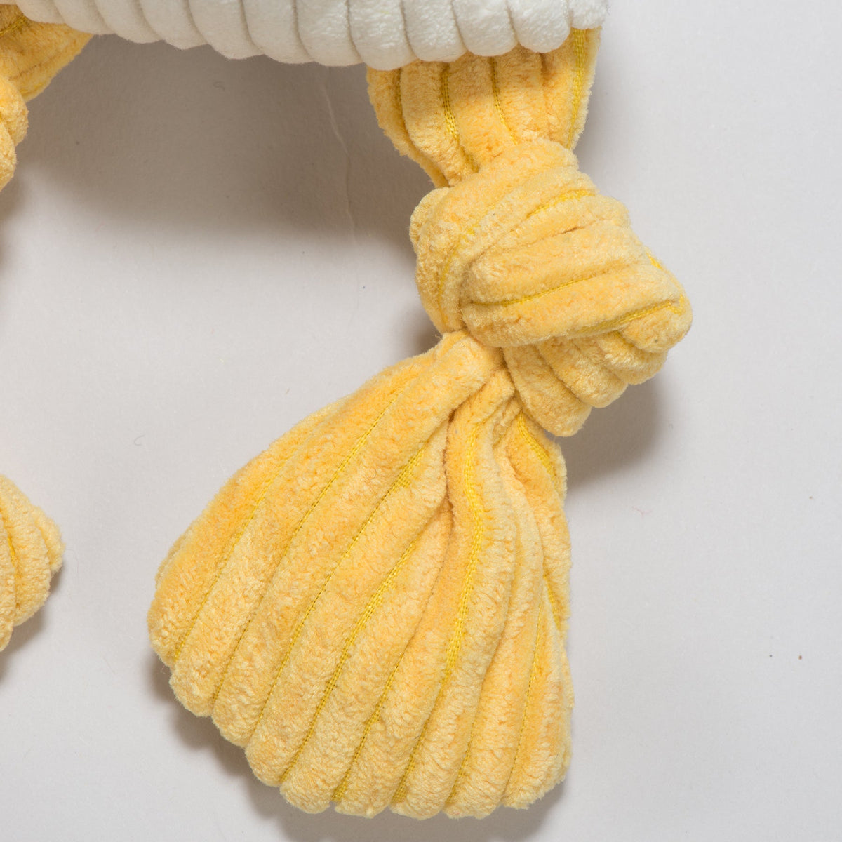 Multicolor Dilly Duck Knottie plush toy from HuggleHounds with a yellow bill and green tail