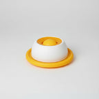 Yellow lick slow feeder toy for cats, made to slow down and stretch out mealtime