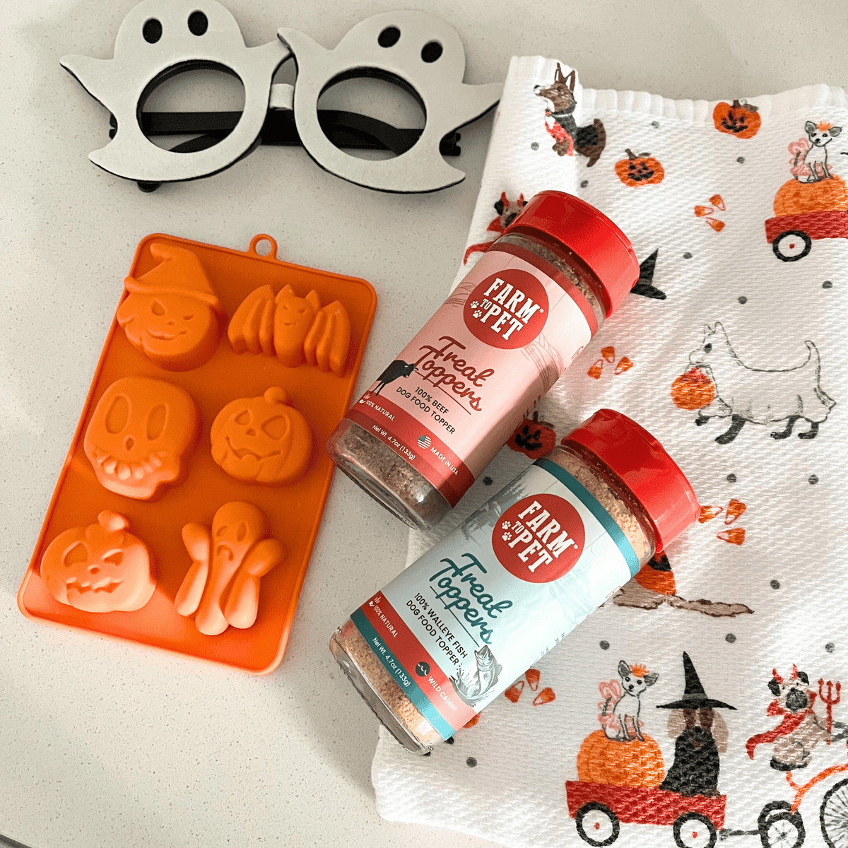 Orange Halloween mold filled with homemade treats, a SodaPup silicone mold from Farm to Pet