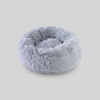 Plush donut comfort pet bed with a round shape that suits natural curling