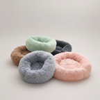 Round donut-shaped pet bed in soft plush fabric for daytime naps and overnight rest
