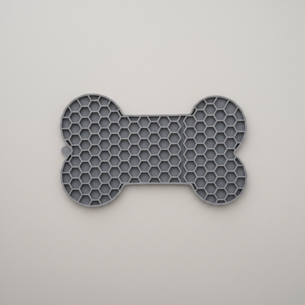 Grey bone-pattern lick mat for dogs and cats, 18 x 11 cm with a non-slip base