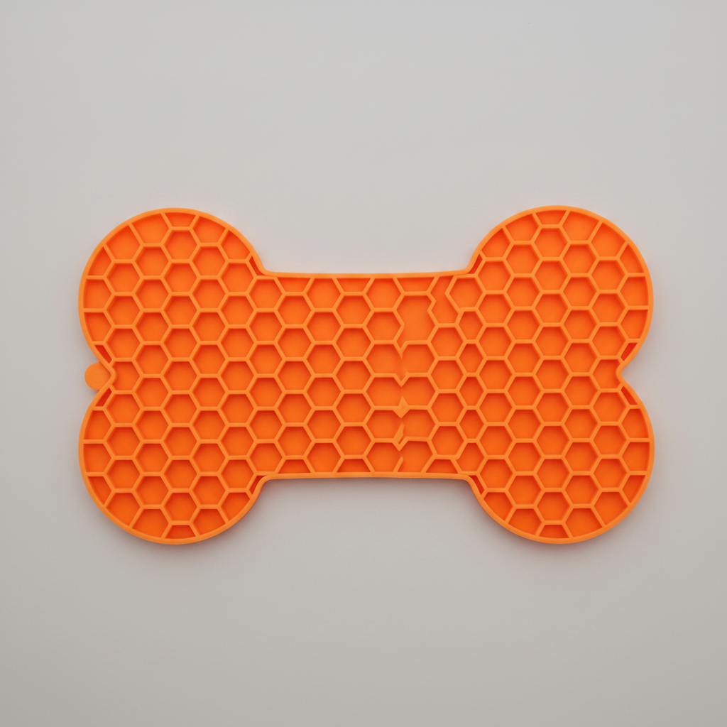 Orange bone-pattern silicone lick mat that stays put on tile and hardwood floors