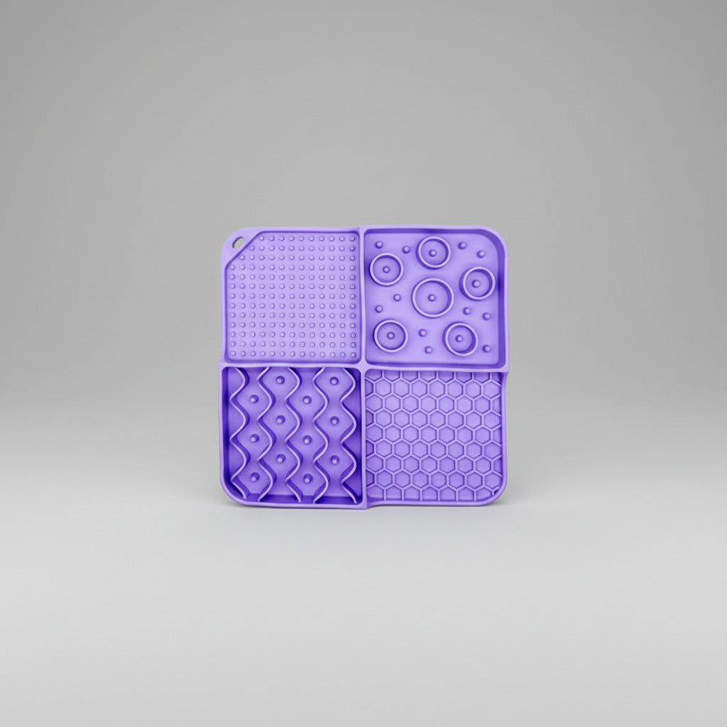 Purple silicone lick mat with a textured surface and suction base for bath time