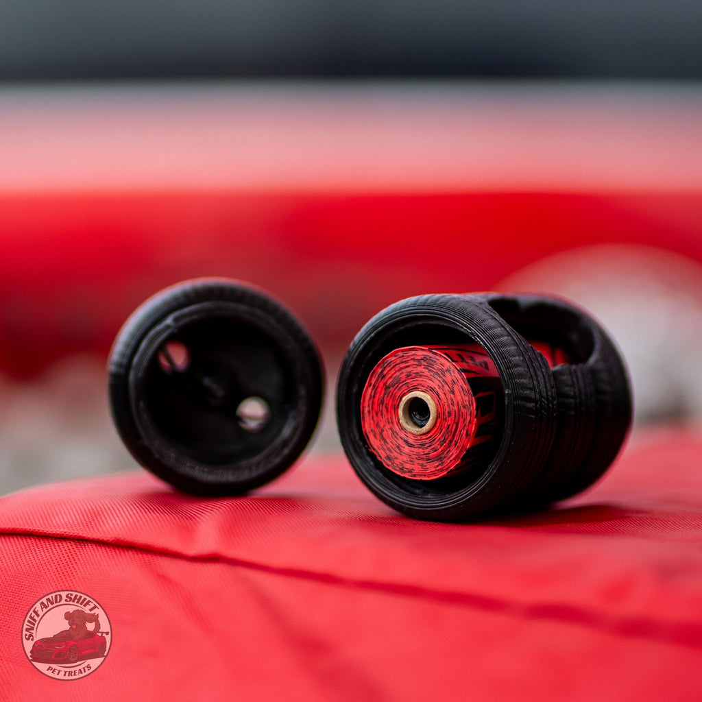 Tire Stack poop bag holder by Sniff and Shift with a roll of strawberry-scented bags inside