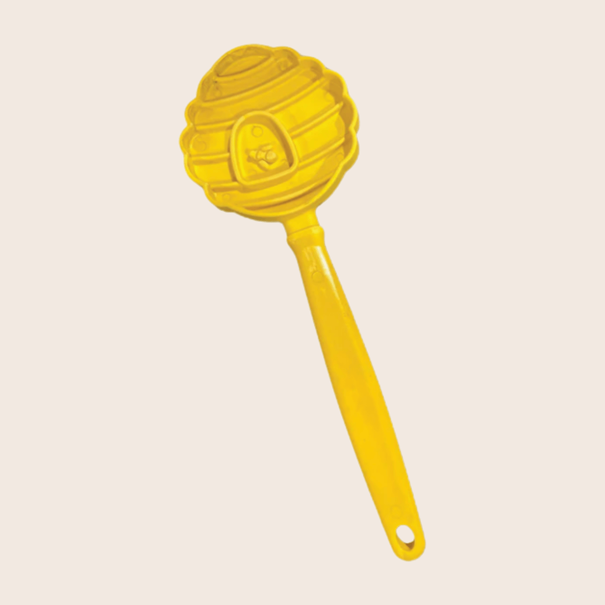 Close-up of the Yellow Beehive lick stick by SodaPup, a hand-held lick mat for dog training